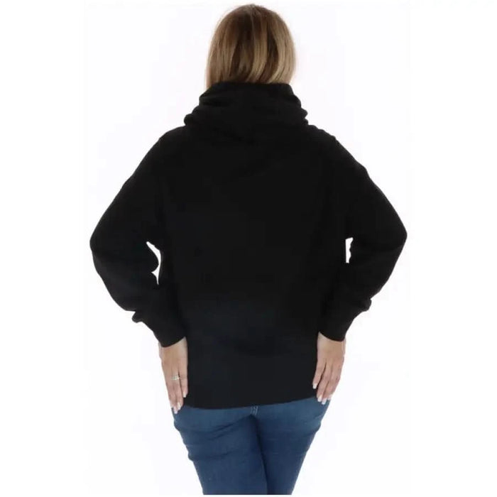 Ellesse Women Sweatshirts - Black turtleneck sweater worn by a person facing away from the camera