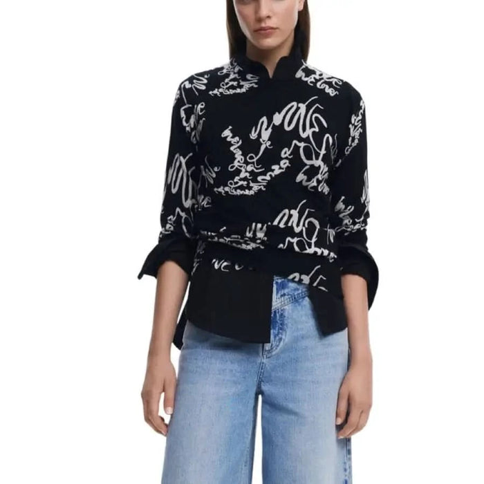 Black and white patterned blouse featured in Desigual Women’s Black Printed Knit Sweater