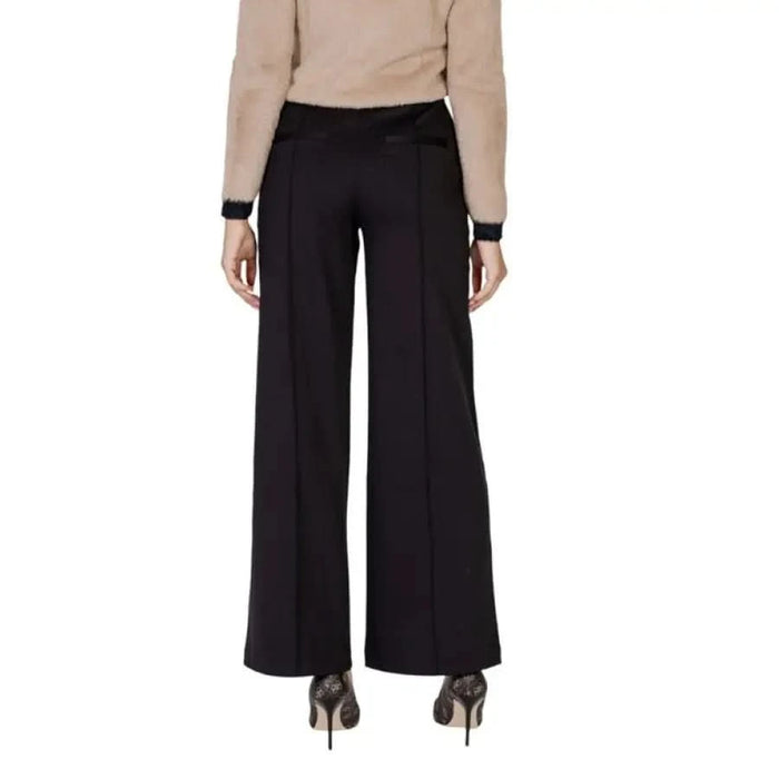 Black wide-leg dress pants with a flowing silhouette by Ichi for women’s fashion