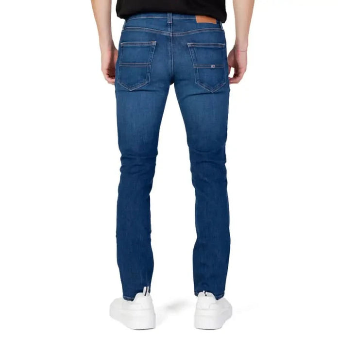 Blue denim jeans by Tommy Hilfiger worn by a person, viewed from behind