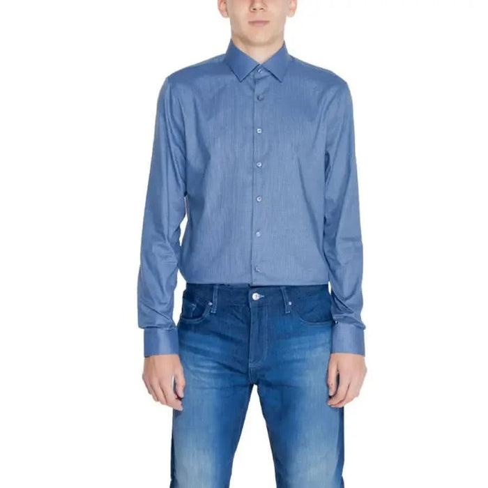 Calvin Klein Men Shirt in blue paired with blue jeans for a stylish and classic look