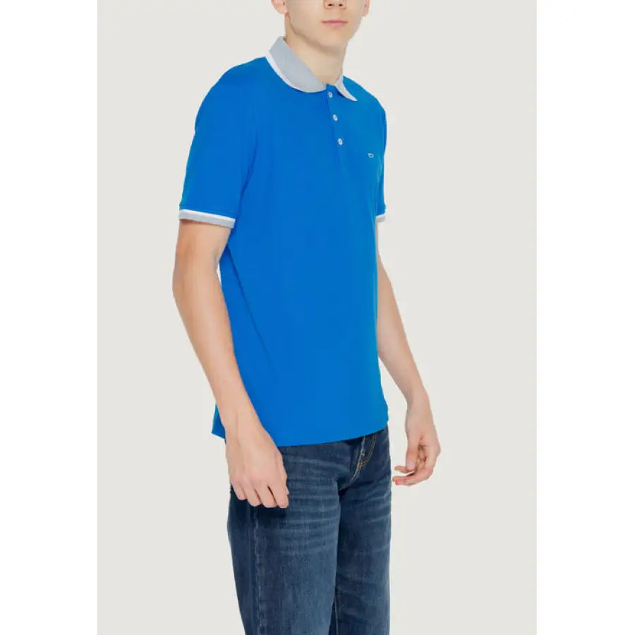 Boy wearing a blue polo shirt from the Gas - Gas Men Polo collection