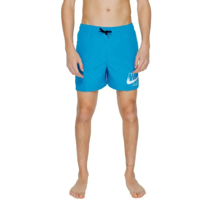 Bright blue Nike swim shorts with white logo featured in Nike Swim Men Swimwear collection