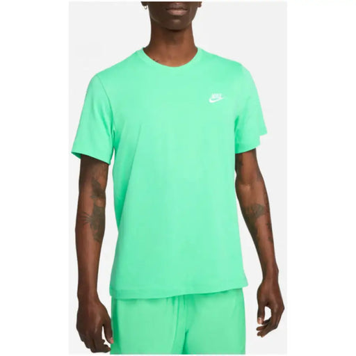 Person wearing a bright mint green Nike T-shirt featured in the Nike Men T-Shirt product line