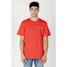 Young man with dark hair wearing a bright red Tommy Jeans T-shirt by Tommy Hilfiger