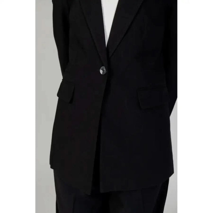 Urban style women blazer, close-up of person in black suit and tie for city fashion