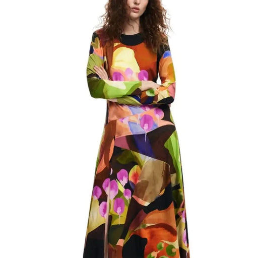 Colorful abstract floral-patterned long-sleeved maxi dress by Desigual on woman with curly hair