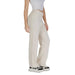 Cream-colored wide-leg trousers with black and white sneakers by Vero Moda