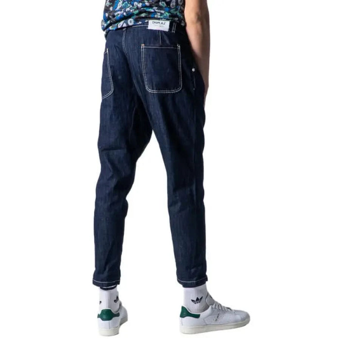 Dark blue denim jeans by Displaj featuring a prominent side pocket and tapered legs