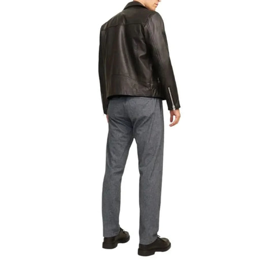 Dark brown leather motorcycle jacket styled with gray pants from Jack & Jones