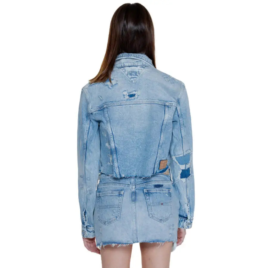 Distressed light blue denim jacket and matching skirt worn by person with long dark hair