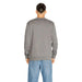 Gray long-sleeved sweatshirt worn by a person from behind in Boss Men Knitwear collection