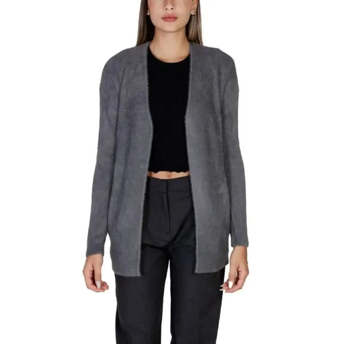 Gray open-front cardigan sweater over black top and pants from Morgan De Toi Knitwear