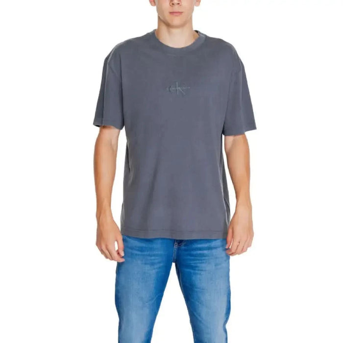 Grey minimalist branded t-shirt paired with blue jeans from Calvin Klein Jeans