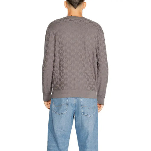 Grey textured geometric knit sweater by Armani Exchange paired with light blue jeans