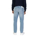 Light blue straight-leg jeans styled with a black sweater and white sneakers from Calvin Klein