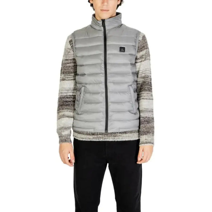 Light gray quilted puffer vest with black zipper and knit sweater sleeves by Gianni Lupo