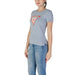 Light gray t-shirt featuring an orange triangular logo from Guess Women’s collection