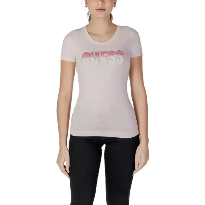 Light pink Guess logo t-shirt styled with dark jeans on model for fashion showcase