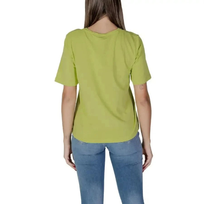 Lime green B.young women’s round neck t-shirt paired with stylish blue jeans