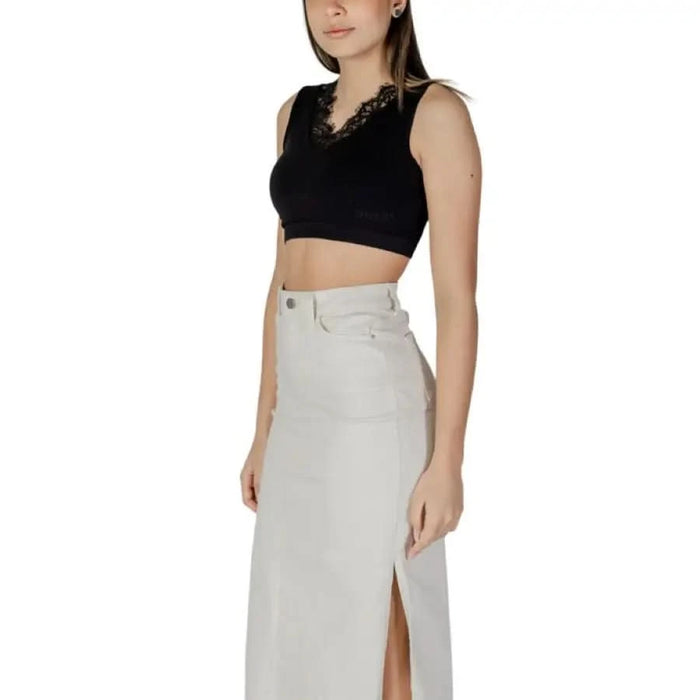 Long white denim skirt with side slit paired with Guess Women’s Black Sleeveless V-Neck Top