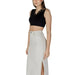 Long white denim skirt with side slit paired with Guess Women’s Black Sleeveless V-Neck Top