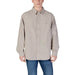 Man in a beige Calvin Klein Jeans long sleeve button-down shirt