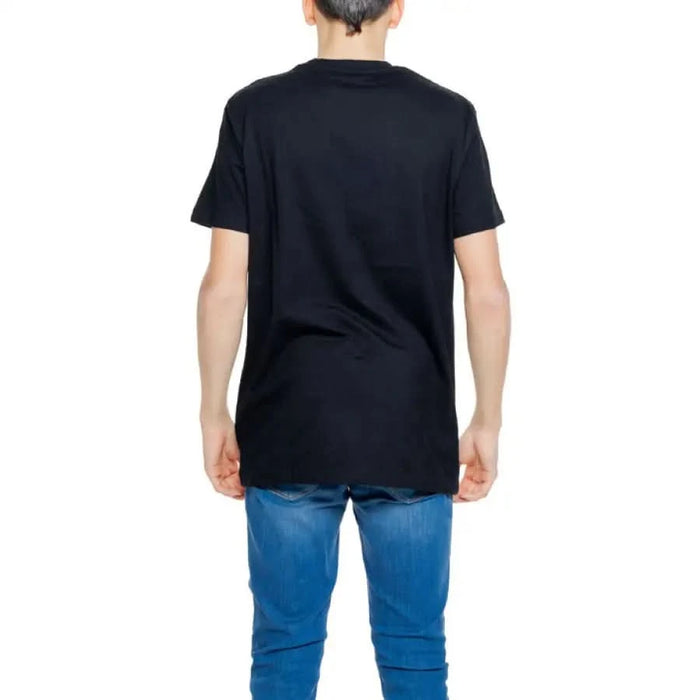 Urban style: Man in black shirt and jeans from Hydra Clothing Men’s T-Shirt collection