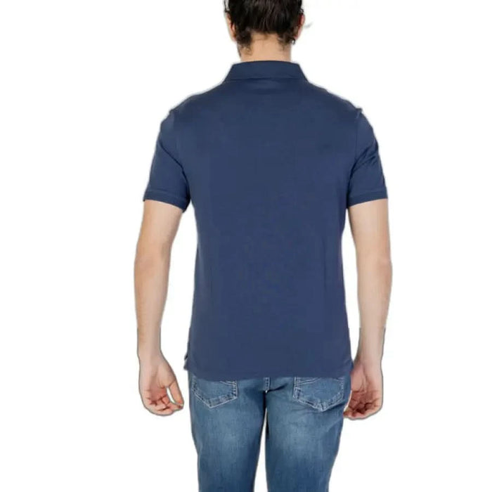 Man in blue Blauer polo showcasing urban city fashion