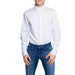 Man wearing Armani Exchange crisp white button-down shirt and blue jeans