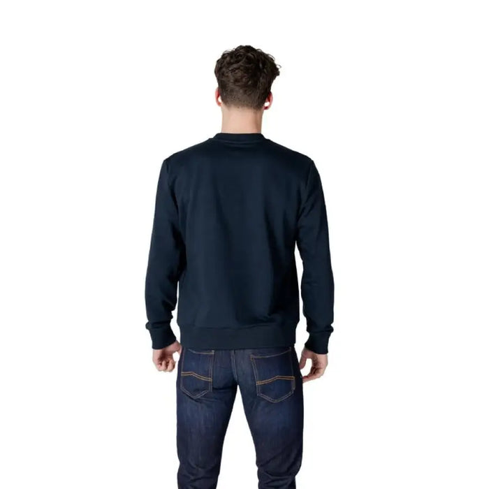 Man in dark blue sweatshirt and jeans wearing Colmar Originals Men’s Blue Sweatshirt