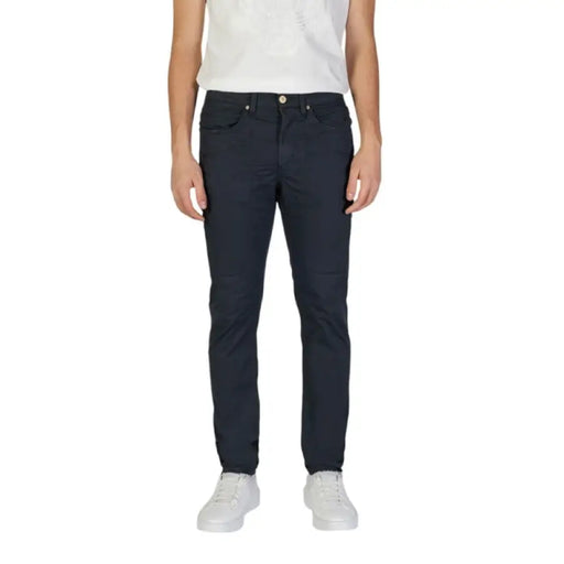 Man in dark blue jeans showcasing Jeckerson Mens Blue Cotton Trousers