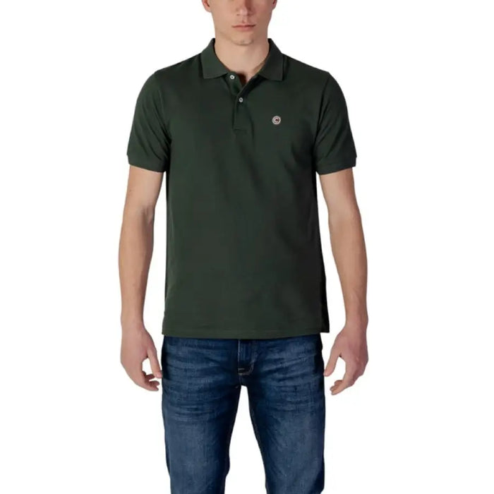 Man in dark green polo shirt and blue jeans showcasing Colmar Originals Men’s Polo