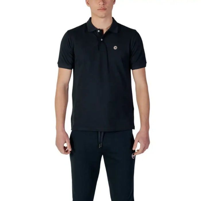 Man wearing Colmar Originals Men’s Blue Cotton Polo with dark polo shirt and sweatpants