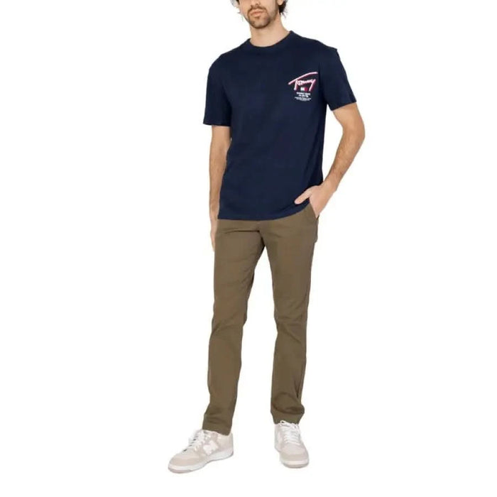 Man in navy blue t-shirt and khaki pants from Tommy Hilfiger Jeans Men T-Shirt collection