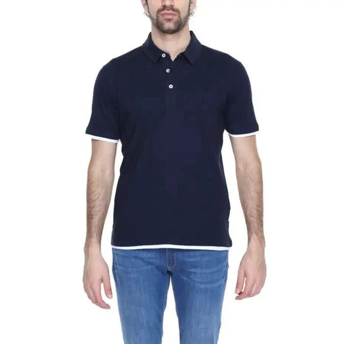 A man wearing a navy Hamaki-ho Men Polo shirt from the Hamaki-ho collection