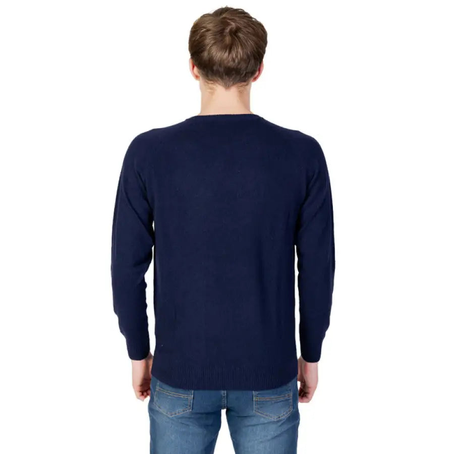Man wearing a navy sweater from U.s. Polo Assn. Men Knitwear collection