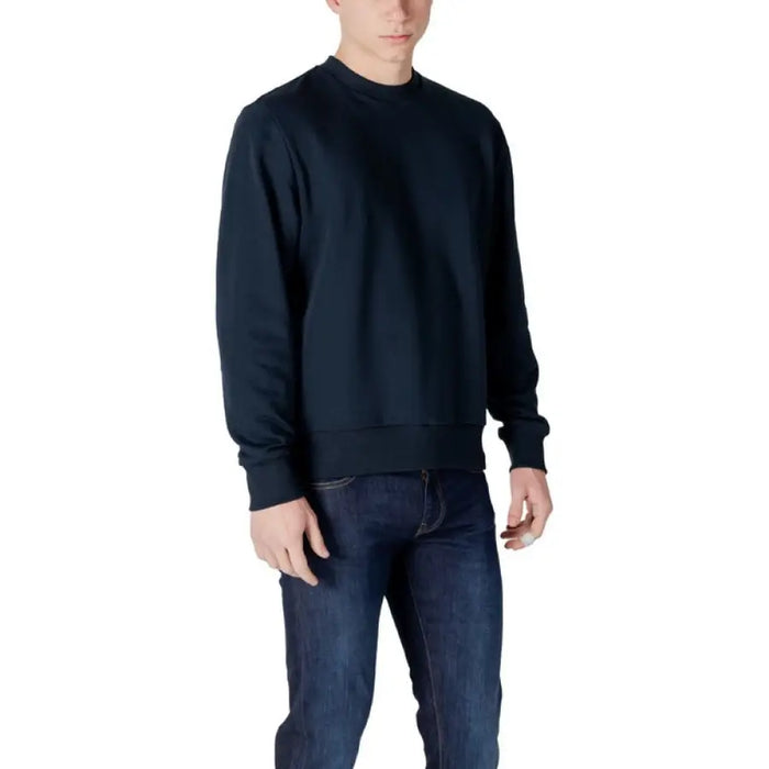 Man wearing Colmar Originals Men’s Blue Sweatshirt with navy sweatshirt and jeans