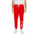 Icon Icon Men wearing red sweat pants with white lettering, Icon Men Trousers