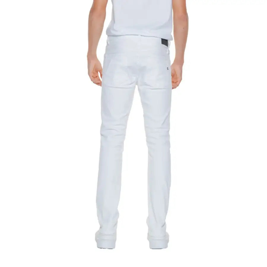 Urban style: a man in white jeans and white t-shirt showcasing Gas Men Jeans