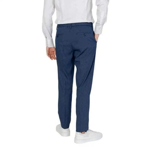 Man modeling Antony Morato men trousers in white shirt and blue pants.