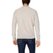 Man wearing white sweater and jeans from Boss Men Knitwear collection