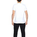 Man in Alviero Martini Prima Classe white t-shirt and black pants