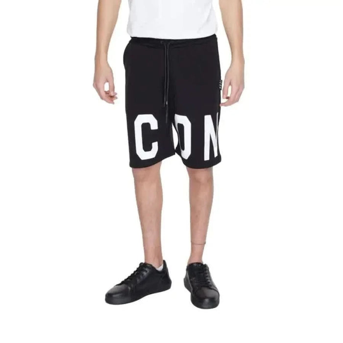 Man in Icon urban style clothing: white t shirt, black Icon Men Shorts