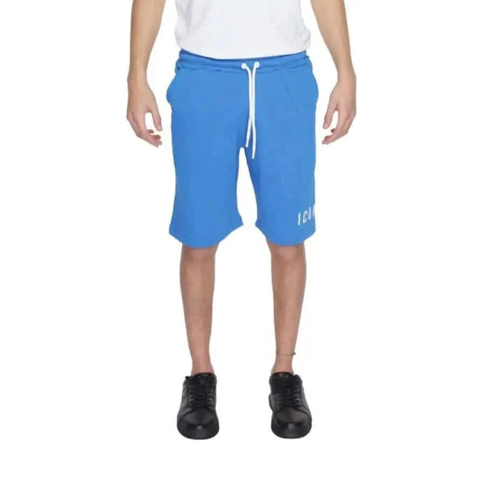 Man in white t-shirt and blue Icon-Icon shorts showcasing urban city style clothing