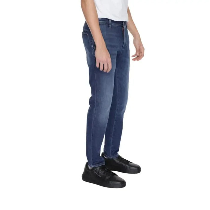 Urban style: Man in white t-shirt and Jeckerson Men Jeans clothing