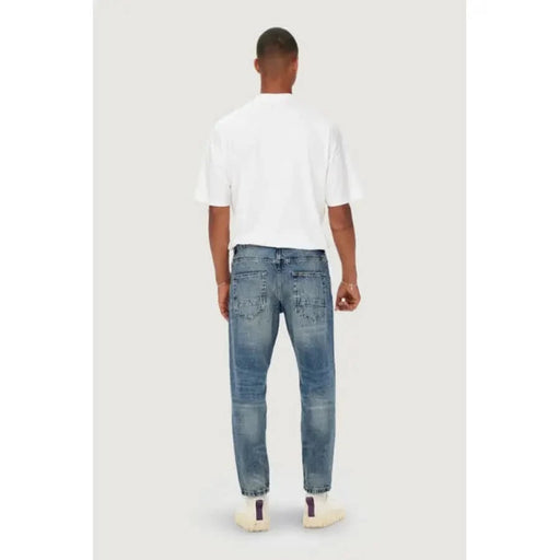 Man in white t-shirt and blue jeans from behind, showcasing Only & Sons Men Jeans