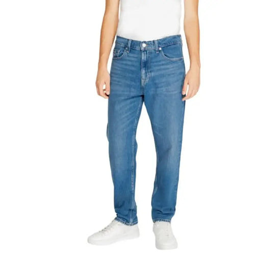 Medium-wash straight-leg denim jeans with five-pocket styling by Tommy Hilfiger