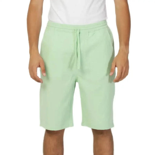 Mint green drawstring shorts worn by a person in a white shirt, Lee - Lee Men Shorts