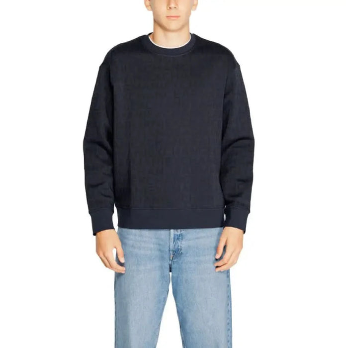 Armani Exchange Men Sweatshirts - Navy blue crewneck sweatshirt worn over light blue jeans